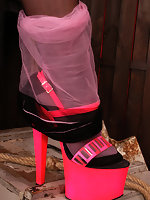 Mature in pink colored stockings over black hose and high heels